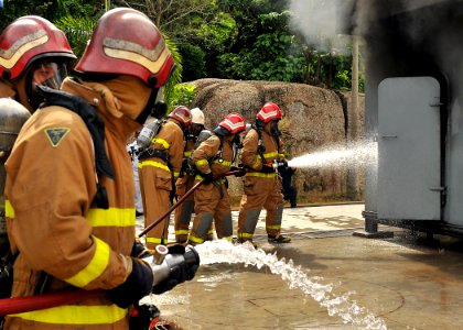 US Navy 100608-N-7643B-280 U.S. Navy Sailors and Coast Guardsmen combat a training fire to demonstrate fire fighting techniques for Royal Malaysian Navy sailors at the Tangkas Fire Training building on the Lumut Naval Base