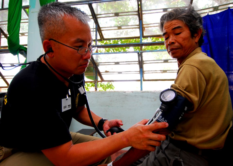 US Navy 100606-N-4044H-159 Lt. Cmdr. Hung Tran checks the blood pressure of a Vietnamese patient during a Pacific Partnership 2010 medical civic action program