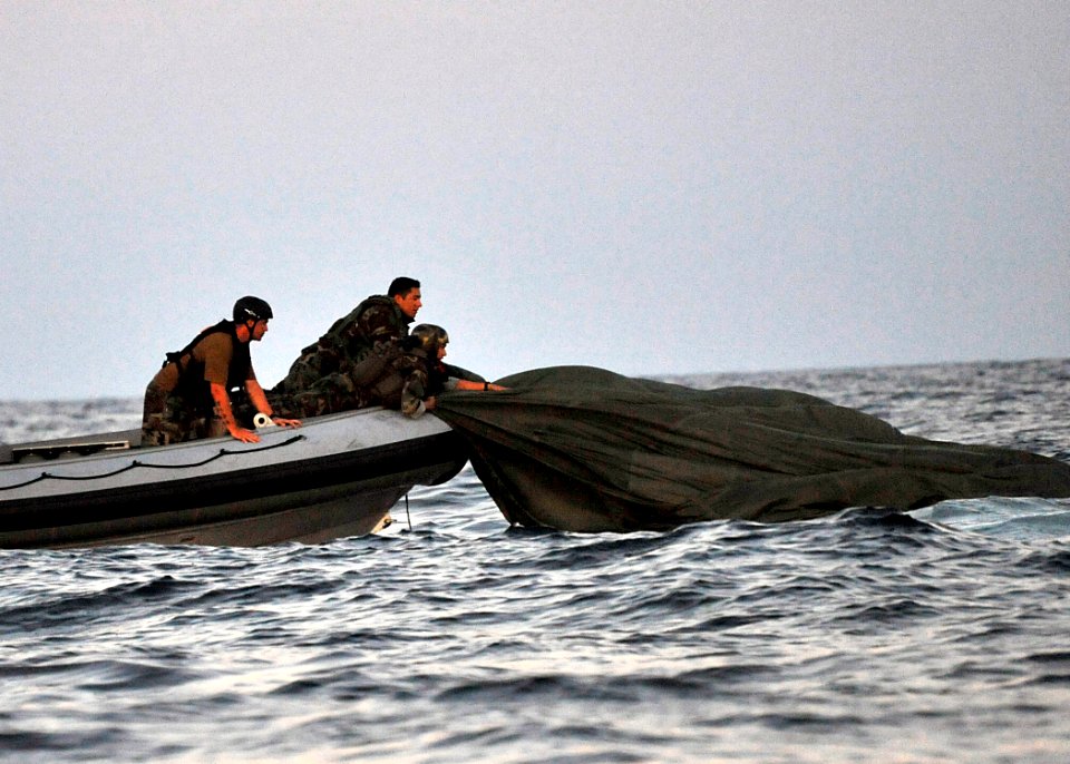 US Navy 100608-N-8689C-094 Navy SEALs and special warfare combatant-craft crewmen recover parachutes and personnel during a maritime craft aerial deployment system exercise near Fort Walton Beach