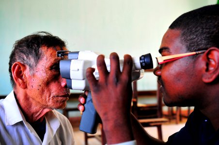 US Navy 100605-N-6597H-023 Hospital Corpsman 2nd Class Cahlil Weaver checks the vision of a Vietnamese woman with an auto refractorduring a Pacific Partnership 2010 medical civic action program photo