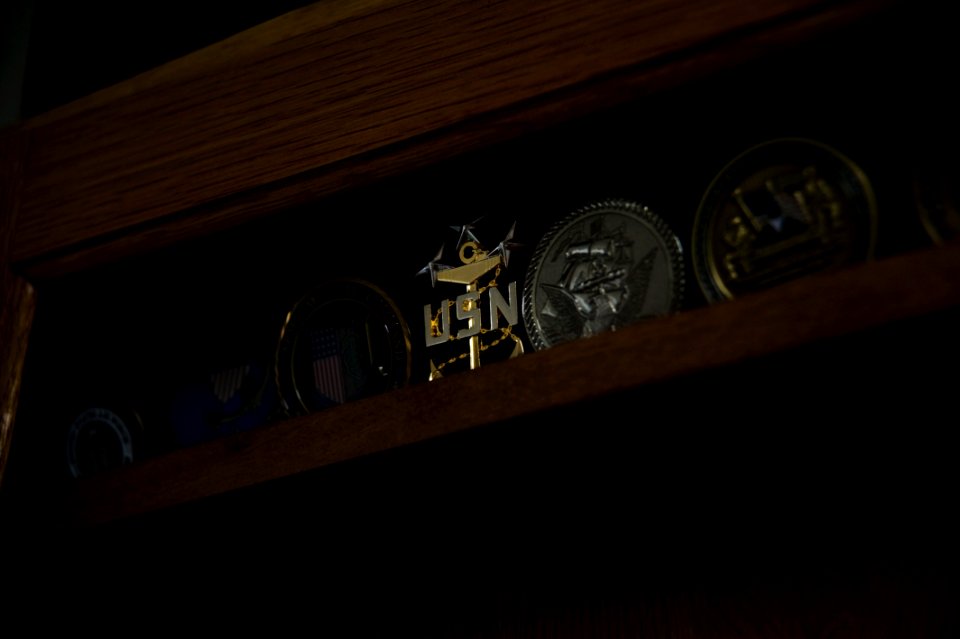 US Navy 100609-N-7526R-104 The coin of Master Chief Petty Officer of the Navy (MCPON) Rick West sits amongst hundreds of other military coins