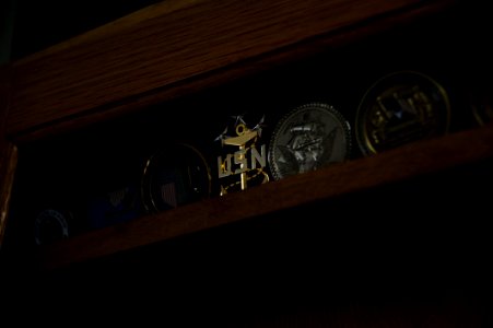 US Navy 100609-N-7526R-104 The coin of Master Chief Petty Officer of the Navy (MCPON) Rick West sits amongst hundreds of other military coins