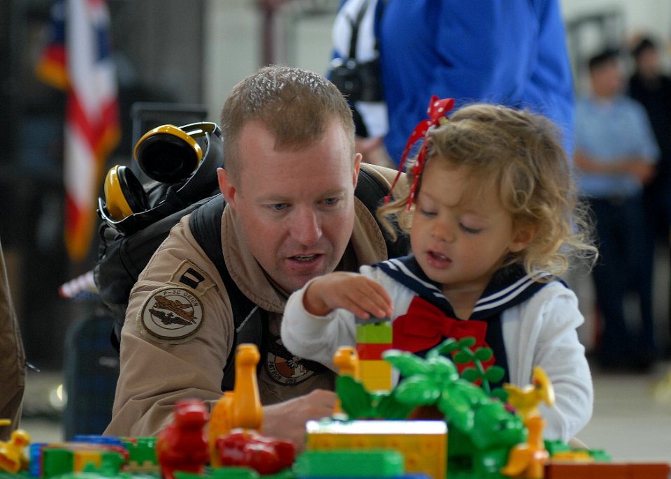 US Navy 100607-N-9520G-006 Lt. John Graham plays with his daughter during a homecoming at Naval Air Station Whidbey Island