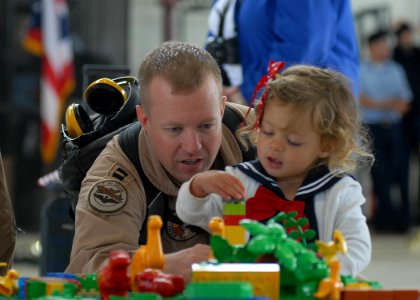 US Navy 100607-N-9520G-006 Lt. John Graham plays with his daughter during a homecoming at Naval Air Station Whidbey Island