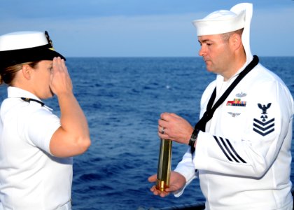 US Navy 100609-N-7908T-291 Lt. Sunny Mitchell salutes Machinist's Mate 1st Class Wesley D. Hatley during a burial at sea for his father photo