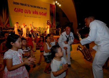 US Navy 100608-N-0209M-020 U.S. Pacific Fleet Band members play and dance with Vietnamese children during a concert at the Nha Van Hoa Lao Dong cultural center in Quy Nhon, Vietnam, supporting Pacific Partnership 2010