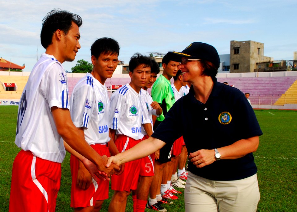 US Navy 100608-N-4044H-061 Capt. Lisa M. Franchetti greets People's Army of Vietnam soldiers before a soccer game during a Pacific Partnership community service project