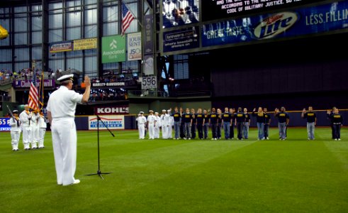 US Navy 100608-N-5208T-005 Rear Adm. Gerald R. Beaman delivers the oath of enlistment to future Sailors at a Milwaukee Brewers baseball game during Milwaukee Navy Week 2010 photo