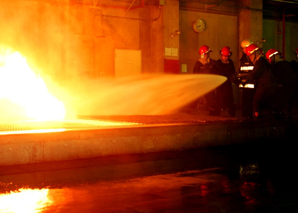 US Navy 100610-N-2218S-002 Sailors assigned to the amphibious transport dock ship USS Denver (LPD 9) fight a controlled fire at the Yokosuka Center for Naval Engineering Firefighting School