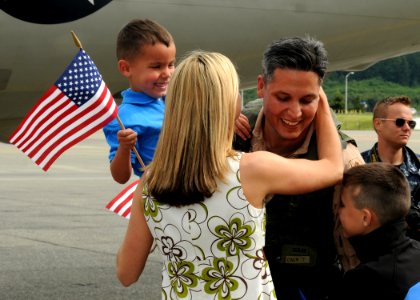 US Navy 100609-N-9860Y-005 Lt. Cmdr. Jaime Hernandez, from El Paso, Texas, the maintenance officer assigned to the Screaming Eagles of Patrol Squadron (VP) 1, is greeted by his wife and children during a homecoming on the Naval