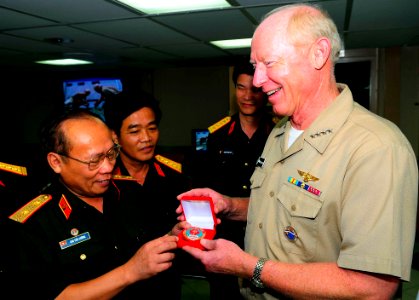 US Navy 100608-N-6410J-104 Adm. Robert F. Willard, commander of U.S. Pacific Command, receives a command coin from People's Army of Vietnam Lt. Gen. Chu Tien Cuong during their visit to the Military Sealift Command hospital shi