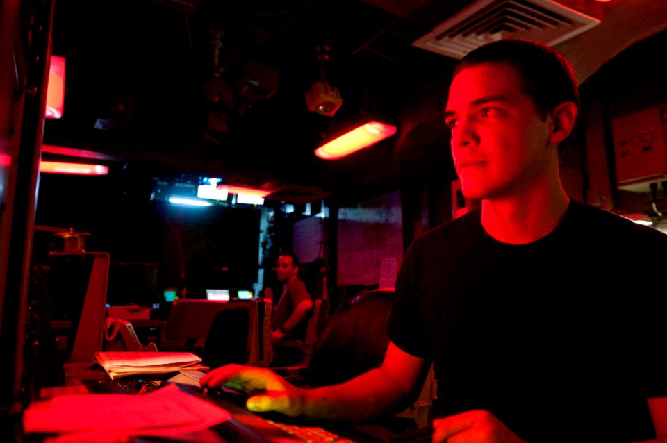 US Navy 100610-N-2735T-074 Operations Specialist 3rd Class Anthony Calvillo monitors transmissions from the flag bridge aboard USS Nassau (LHA 4)
