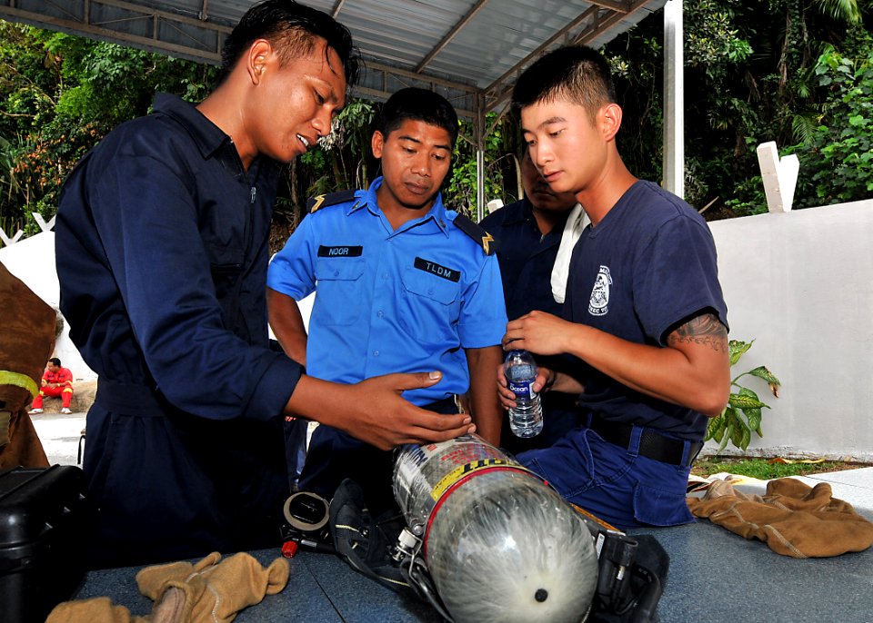US Navy 100608-N-7643B-385 Electronics Technician 2nd Class Kakit Chan, right, assigned to the U.S. Coast Guard cutter Mellon (WHEC 717)