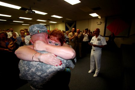 US Navy 100610-N-4482V-003 Senior Chief Engineman Henry Hewitt surprises his wife Tammy, during a Naval Education and Training Command (NETC) all-hands meeting