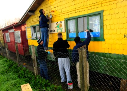 US Navy 100608-N-9301W-213 Sailors assigned to the guided-missile frigate USS Klakring (FFG 42) paint the shingles of a preschool