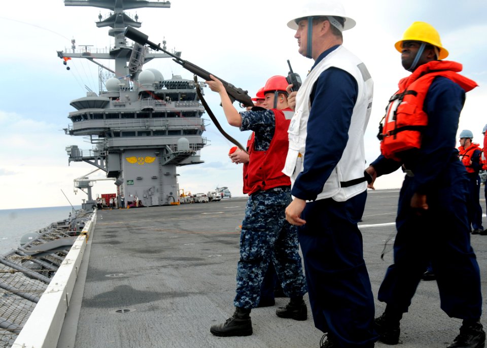 US Navy 100610-N-7908T-011 Aviation Ordnanceman Airman Jacquelyn A. Herron, assigned to the aircraft carrier USS George H.W. Bush (CVN 77), fires an M-14 rifle
