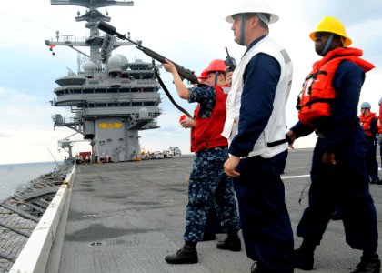 US Navy 100610-N-7908T-011 Aviation Ordnanceman Airman Jacquelyn A. Herron, assigned to the aircraft carrier USS George H.W. Bush (CVN 77), fires an M-14 rifle