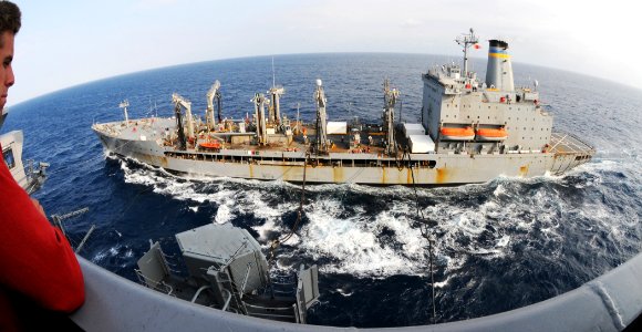 US Navy 100610-N-8913A-074 Midshipman 2nd Class Tyler Griffith watches as the Military Sealift Command fleet replenishment oiler USNS Leroy Grumman (T-AO 195) conduct replenishment