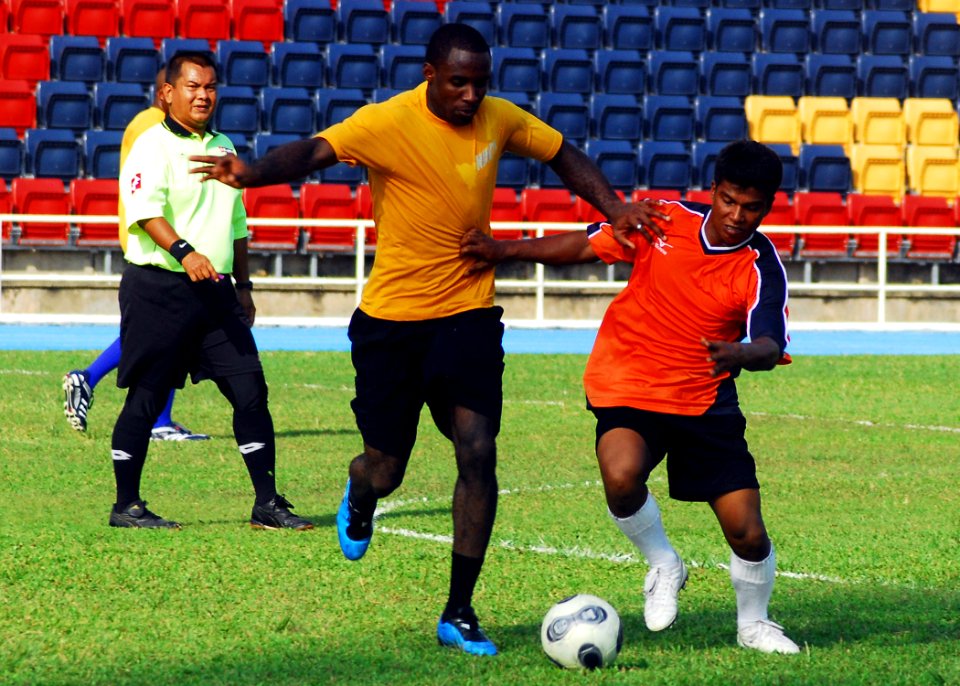 US Navy 100611-N-0995C-160 Ship's Serviceman Seaman Chika Ndubizu assigned to the guided-missle frigate USS Vandegrift (FFG 48) works to keep possession of the ball