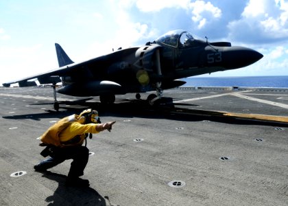 US Navy 100611-N-1226D-446 A Sailor gives the launch signal to a Marine Corps AV-8B Harrier pilot