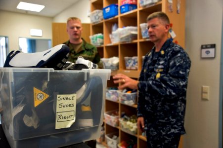 US Navy 100609-N-7526R-141 Religious Programs Specialist 2nd Class Nathan Vandenberg explains to Master Chief Petty Officer of the Navy (MCPON) Rick West the services and supplies available to wounded and amputated personnel