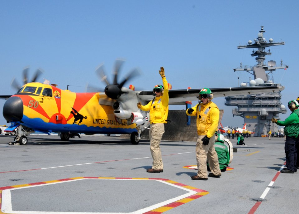 US Navy 100611-N-6509M-926 Shooters prepare a C-2A Greyhound assigned to Fleet Logistics Support Squadron (VRC) 40 for launch aboard the aircraft carrier USS George H.W. Bush (CVN 77)