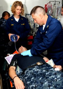 US Navy 100611-N-7908T-041 Lt. Cmdr. Kimberly M. Stack, left, an anesthesiologist assigned to the aircraft carrier USS George H.W. Bush (CVN 77)