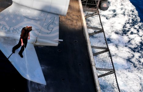 US Navy 100612-N-3595W-003 A Sailor assigned to the Patriots of Electronic Attack Squadron (VAQ) 140, cleans an EA-6B Prowler on the flight deck of the aircraft carrier USS Dwight D. Eisenhower (CVN 69)
