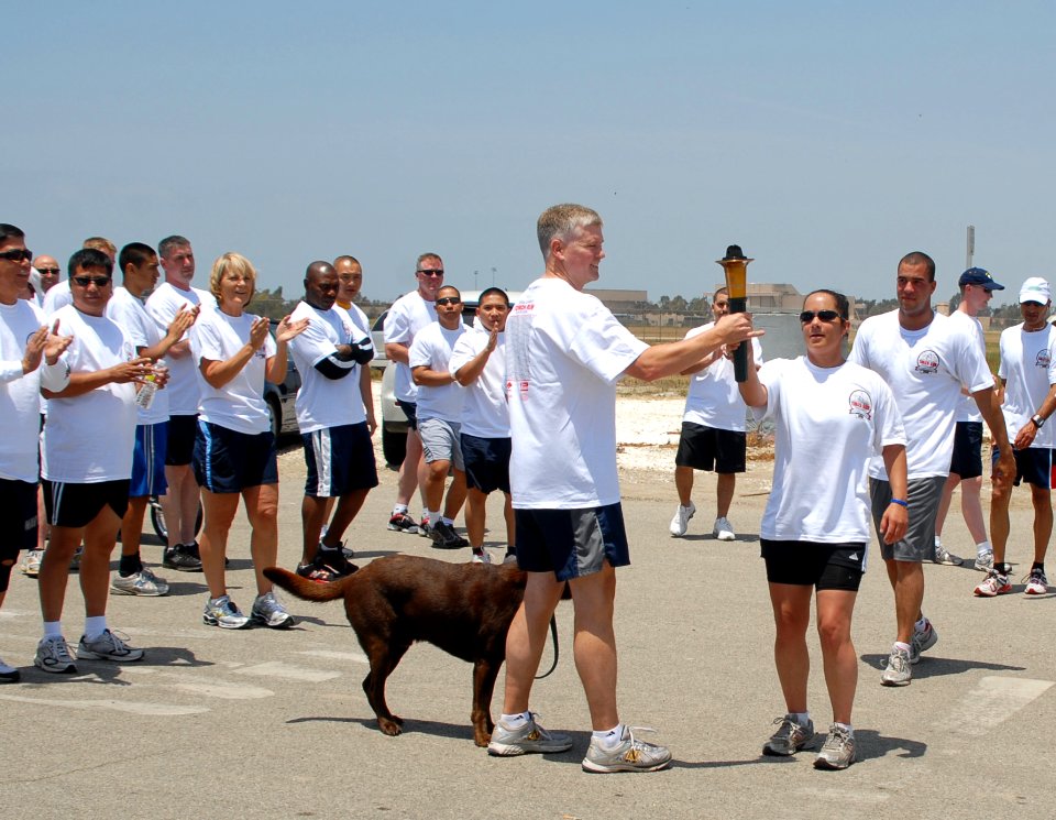 US Navy 100610-N-6865V-002 Capt. James McHugh, commanding officer of Naval Base Ventura County accepts the Flame of Hope torch from members of the Port Hueneme Law Enforcement relay group