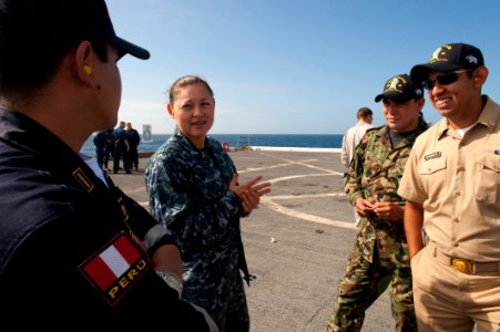 US Navy 100612-N-5319A-233 Aviation Boatswain's Mate (Fuel) Airman Karina Allain speaks with foreign military embarked aboard the amphibious transport dock ship USS New Orleans (LPD 18)