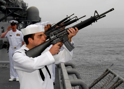 US Navy 100610-N-8283S-046 A rifle squad from the amphibious assault ship USS Boxer (LHD 4) fire a 21-gun salute during a burial at sea photo
