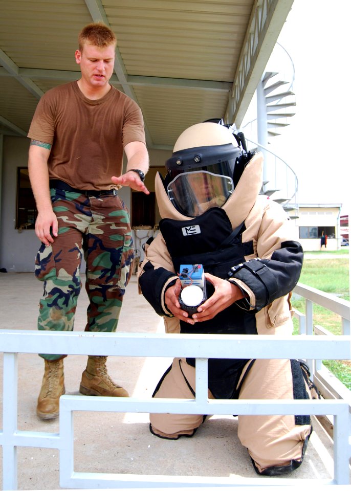 US Navy 100609-N-8539M-096 A U.S. and a Cambodian service member approach a simulated improvised explosive device