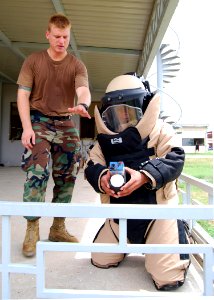 US Navy 100609-N-8539M-096 A U.S. and a Cambodian service member approach a simulated improvised explosive device photo