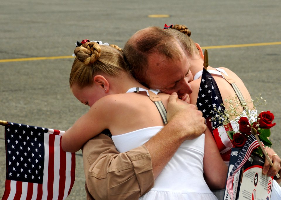 US Navy 100609-N-9860Y-003 Chief Naval Aircrewman Stan Culbertson is greeted by his daughters during a homecoming at Naval Air Station Whidbey Island