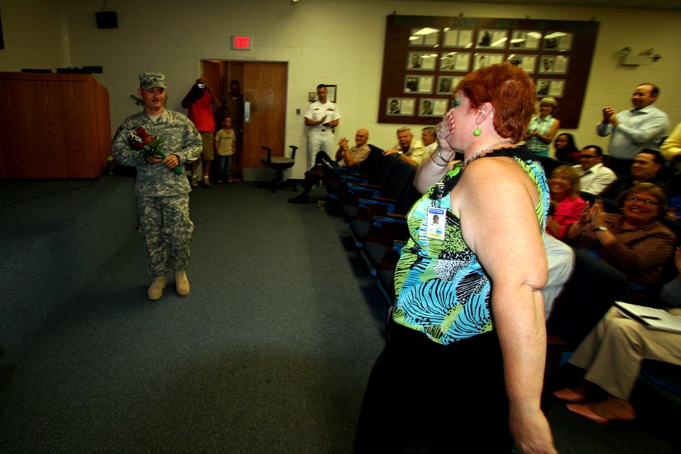 US Navy 100610-N-4482V-001 Senior Chief Engineman Henry Hewitt surprises his wife Tammy, during a Naval Education and Training Command (NETC) all-hands meeting