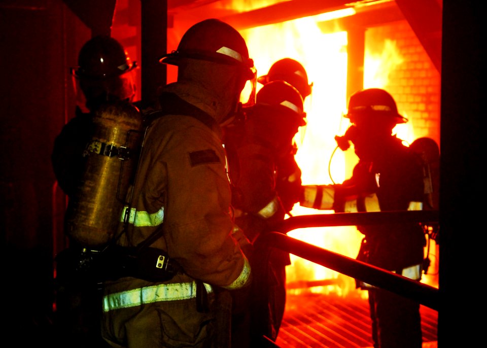 US Navy 100610-N-2218S-004 Sailors assigned to the amphibious transport dock ship USS Denver (LPD 9) enter a space to combat a controlled fire at the Yokosuka Center for Naval Engineering Firefighting School