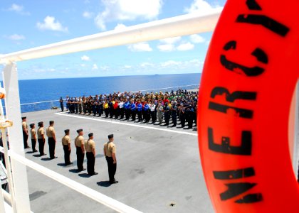 US Navy 100613-N-4044H-117 Newly frocked 1st class petty officers stand in formation as they are congratulated during a frocking ceremony on the flight deck aboard the Military Sealift Command hospital ship USNS Mercy (T-AH 19)