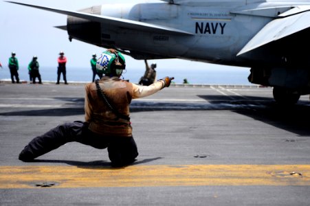 US Navy 100613-N-6604E-236 Aviation Machinist's Mate 2nd Class Clarice Taylor verifies equipment is operating safely prior to the launch of an F-A-18F Super Hornet aboard USS Dwight D. Eisenhower (CVN 69)