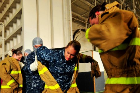 US Navy 100610-N-4053P-023 Sailors assigned to the aircraft carrier USS Nimitz (CVN 68) don fire fighting ensembles during an in-port general quarters drill. Nimitz is homeported at Naval Base Coronado
