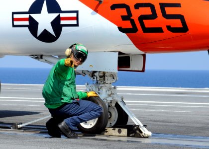 US Navy 100613-N-6509M-009 A Sailor performs a pre-flight check on a T-45A Goshawk aboard USS George H.W. Bush (CVN 77)