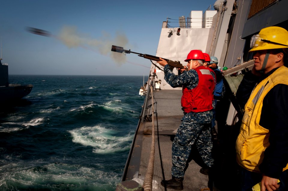 US Navy 100610-N-5319A-231 Gunner's Mate 2nd Class Steven Moore assigned to the amphibious transport dock ship USS New Orleans (LPD 18) fires the shot-line
