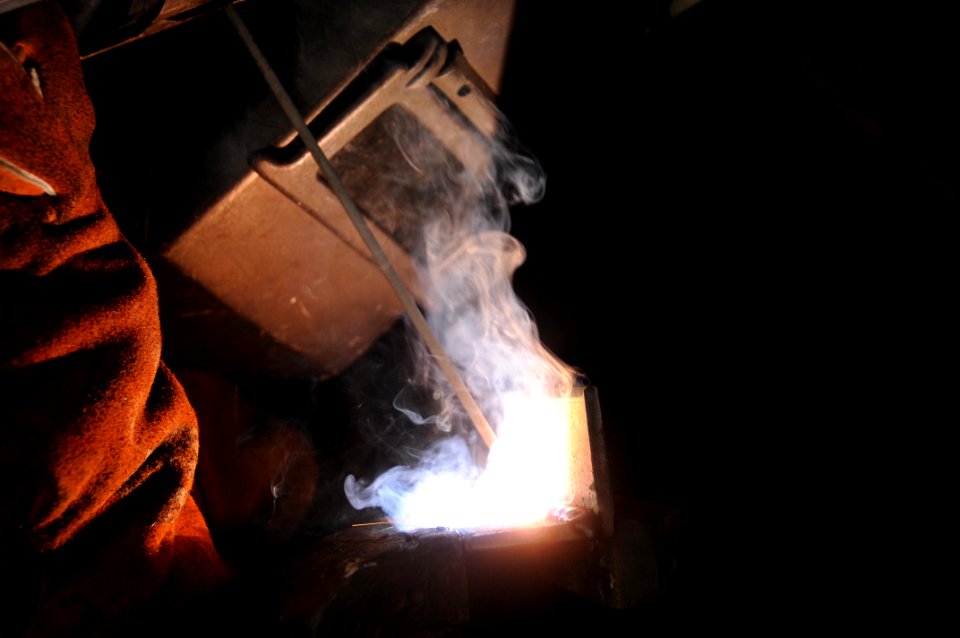 US Navy 100610-N-5712P-101 Hull Maintenance Technician 3rd Class Andrew Stewart, from Madison, Ohio, welds a bracket that will be used for mounting a television