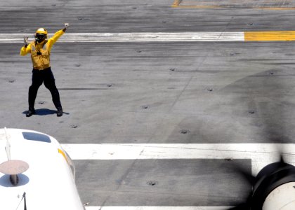 US Navy 100612-N-8913A-027 A Sailor directs an aircraft on the flight deck of the aircraft carrier USS George H.W. Bush (CVN 77)
