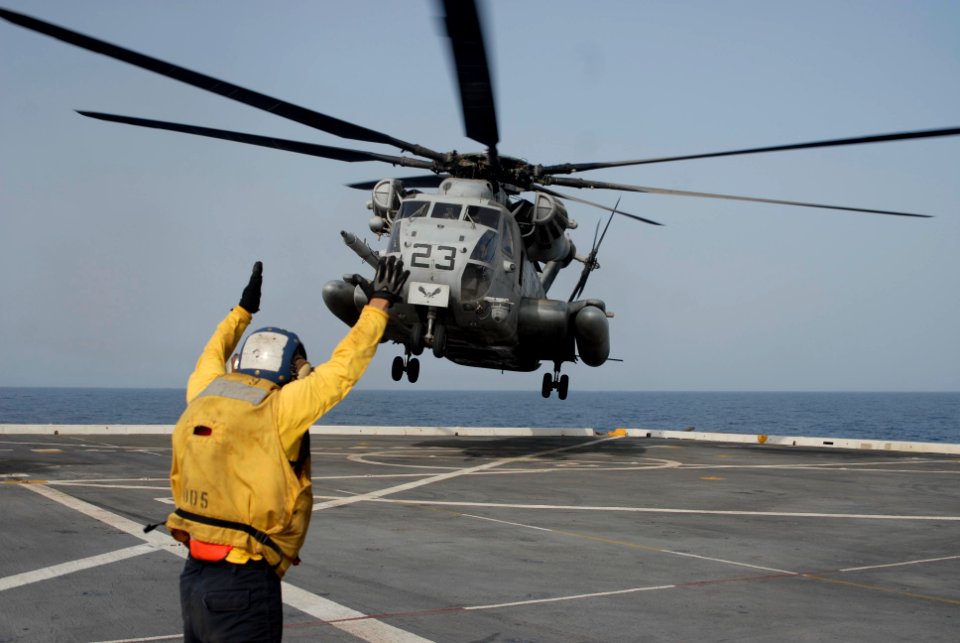 US Navy 100613-N-3358S-228 A landing safety enlisted (LSE) directs a CH-53E Super Stallion helicopter