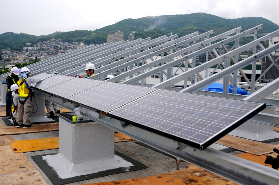 US Navy 100614-N-8335D-090 Japanese contractors install solar panels on the Public Works building roof at Fleet Activities Sasebo, Japan