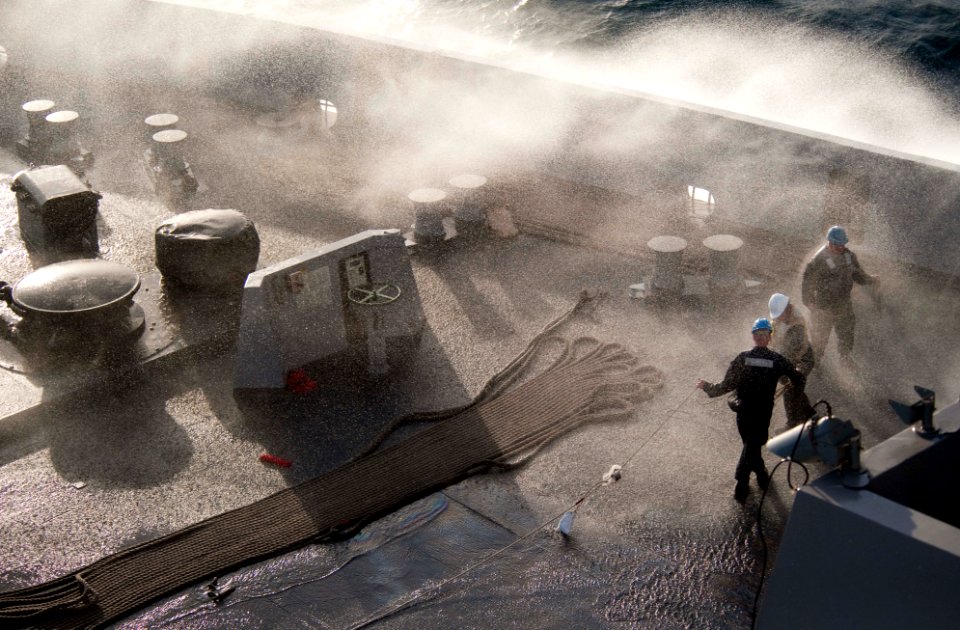 US Navy 100610-N-5319A-267 Sailors on the bow of the amphibious transport dock ship USS New Orleans (LPD 18) receive some sea spray. as they stow gear away