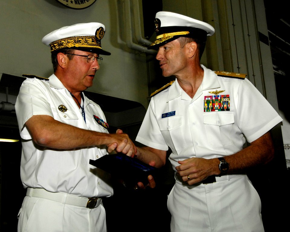 US Navy 100613-N-6362C-212 Rear Adm. Patrick Driscoll, right, commander of Strike Group 10, presents a gift to French navy Vice Admiral Yann Tainguy