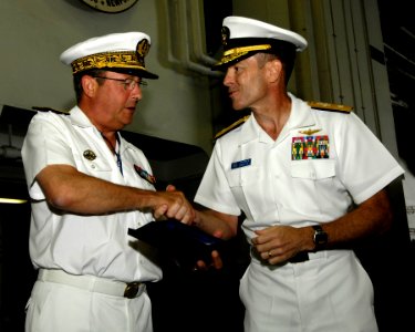 US Navy 100613-N-6362C-212 Rear Adm. Patrick Driscoll, right, commander of Strike Group 10, presents a gift to French navy Vice Admiral Yann Tainguy