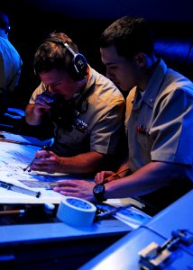US Navy 100615-N-2218S-003 Operations Specialist 3rd Class Alexander Ruiz, right, and Operations Specialist 3rd Class Jonathan Schnider, assigned to the amphibious transport dock ship USS Denver (LPD 9),