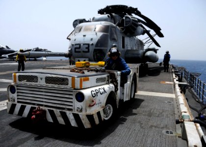 US Navy 100610-N-8936G-076 Airman Erin Williams, of Odon, Ind., tows a CH-53E Sea Dragon helicopter across the flight deck of the amphibious assault ship USS Nassau (LHA 4)